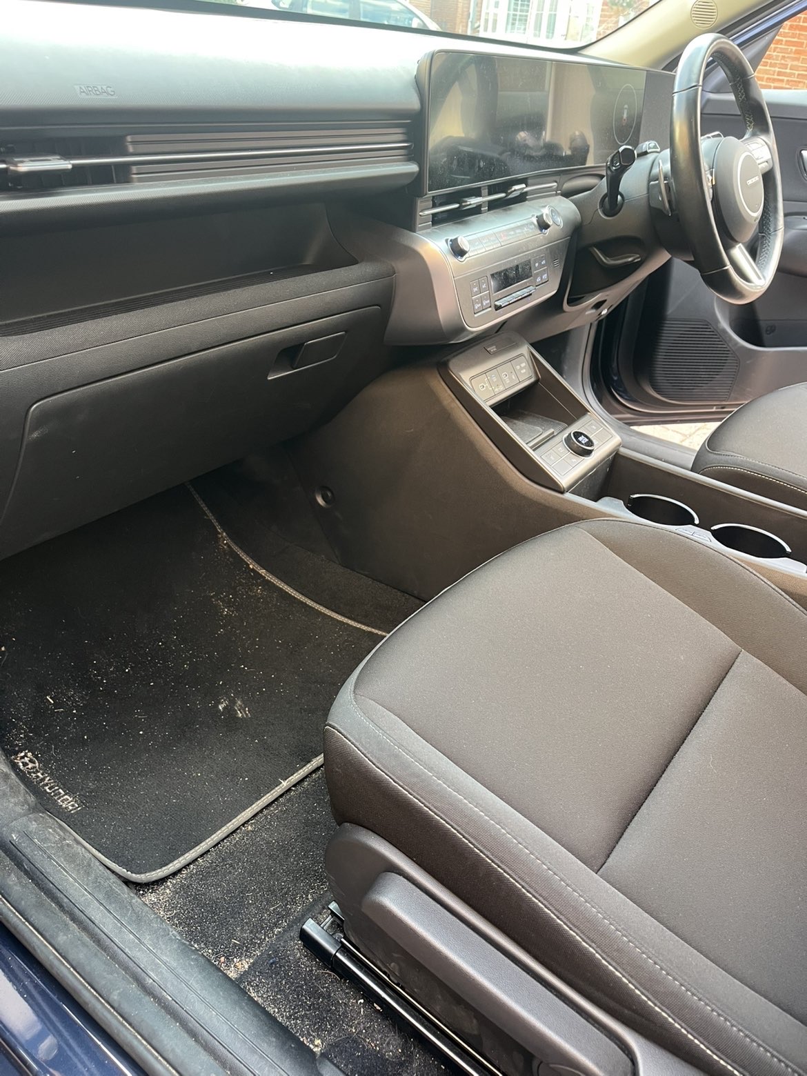 Passenger footwell with debris before detailing